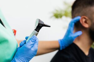 person holding otoscope